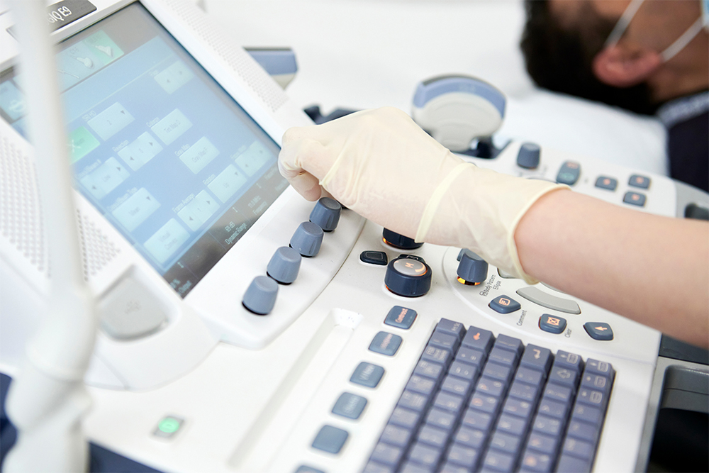 Close up shot of a sonographer using an ultrasound machine